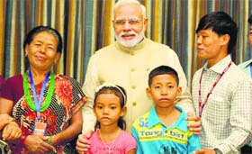 PM Narendra Modi with the family of Jeet Bahadur (R) in Kathmandu on Sunday. The young boy has been raised by the PM in Gujarat, India.