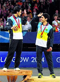 Parupalli  Kashyap and bronze medalist RV Gurusaidutt go for a high five at the podium. PTI 