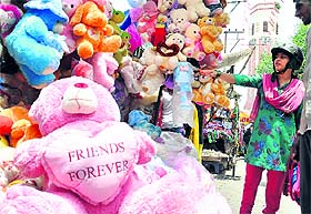 A woman selects a teddy bear at Paltan Bazaar in Dehradun on Sunday.