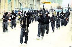 Fighters of Islamic State of Iraq and the Levant, now known as Islamic State, carry their weapons during a parade in the Syrian town of Tel Abyad.
