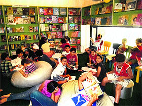 Children read and discuss books at the book club at One Up Library