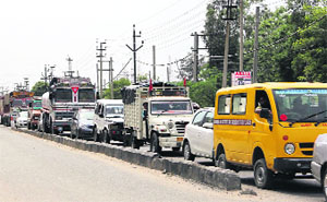 Long queues of vehicles seen at the railway crossing near the Guru Nanak Dev Thermal Plant where the construction of an ROB is likely to start soon.
