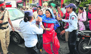 Agitating ETT teachers being rounded up during a protest at Hanuman Chowk in Bathinda on Monday.