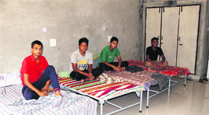 Boys relax on the cots in the rooms allotted to them at Senior Secondary School for Meritorious School in Bathinda on Monday.