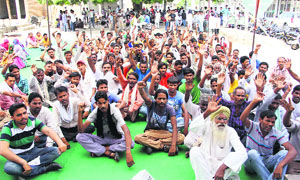 Members of the Municipal Workers Union and safai karamcharis protest against the state government in Bathinda on Monday. 