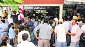 Onlookers gather outside the shop after the incident.