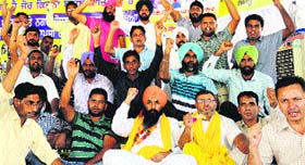 ETT teachers hold a protest at Phase VIII, Mohali, on Monday.