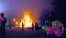 A vendor sells balloons on a misty evening on the Ridge in Shimla on Sunday. 