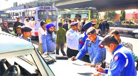 Traffic police officials challan minibuses at the Dogra Chowk in Jammu. 