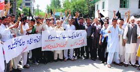 Residents of Wilgam village, Kupwara, hold a protest demanding tehsil status for their village in Srinagar on Monday.