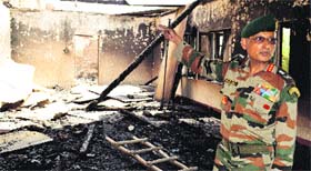 Lt General Subrata Saha, GoC, 15 Chinar Corps, inspects the area where two hostel buildings were gutted at Manasbal in Ganderbal on Sunday night.
