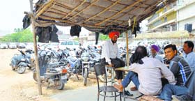 Parking attendants at Books Market charge visitors at whims