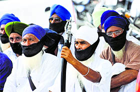 Members of the Shri Guru Granth Sahib Satkar Sabha stage a silent protest outside the Mini Secretariat in Karnal on Monday.