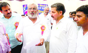 Health Minister Surjit Jyani (second from left) addresses a gathering in Abohar on Monday.