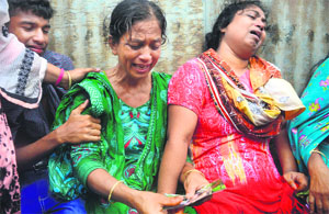 Bangladeshis mourn their missing relatives after an overloaded ferry capsized in the Padma river in Munshiganj on Monday.