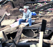 A woman waits for rescuers to search for her relatives who are buried under the collapsed buildings.