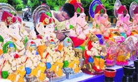 DEEP DEVOTION: An artist gives final touches to an idol of Lord Ganesha ahead of Ganesh Chaturthi in Amritsar on Tuesday.