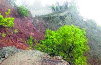 A stretch of the Panchkula-Morni road that caved in due to a landslide in Thana village near Morni on Tuesday. a Tribune photograph