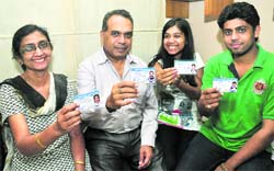 Family members show donation cards at their house in Sector 50, Chandigarh, on Tuesday. Tribune photo: Parvesh Chauhan