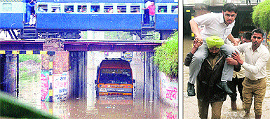 A bus of Cambridge International School stranded under the deluged Domoria underpass in Jalandhar on Tuesday; and (right) a student of the school being rescued from the stranded school bus under the deluged Domoria underbass by the driver and conductor. 