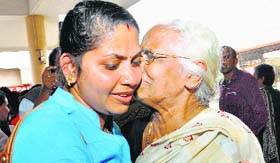 A relative greets a nurse evacuated from Libya in Kochi.
