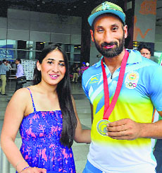Sardar Singh with his fiancee Ashpal Bhogal on their arrival at the IGI Airport in New Delhi on Tuesday.