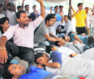 Contractual polytechnic teachers protest at Parade Ground in Dehradun on Tuesday.