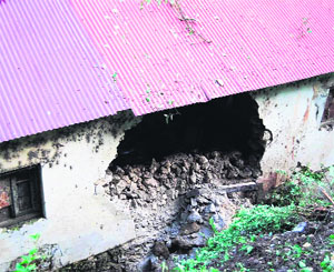 A house damaged due to a landslide in Mussoorie.