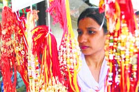 Bond of love: A woman looks at a rakhi ahead of the Hindu festival of Raksha Bandhan in Amritsar on Wednesday