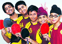 Paddlers of Manav Mangal Smart School, Mohali, and Gurukul Global School, Mani Majra in a jubilant mood after winning the girls' and boys' team event, respectively, in Mohali on Wednesday