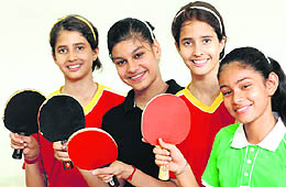Paddlers of Manav Mangal Smart School, Mohali, and Gurukul Global School, Mani Majra in a jubilant mood after winning the girls' and boys' team event, respectively, in Mohali on Wednesday