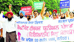 Members of the Government Teachers Union (Punjab) hold a protest at Phase VIII in Mohali on Wednesday