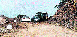 Vehicles commute through a kutcha stretch on the Panchkula-Morni road on Wednesday
