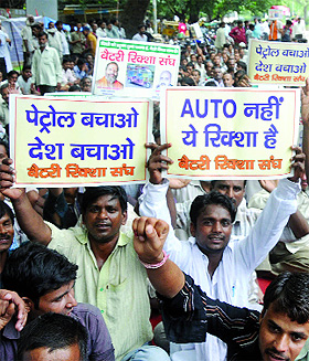 E-rickshaw drivers raise slogans during a demonstration against the Delhi High Court order directing a halt to the plying of the battery-operated vehicles, at Jantar Mantar on Wednesday.
