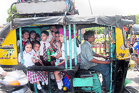 Overloaded auto-rickshaws ferrying schoolchildren in Jalandhar.