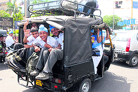 Overloaded auto-rickshaws ferrying schoolchildren in Jalandhar.