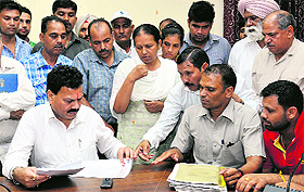 National SC Commission Vice-President Dr Raj Kumar Verka meets the family of bank manager Jagir Chand, who had died during his retirement party, in Jalandhar on Wednesday. 