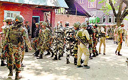 Security personnel during a search operation in Baramulla district on Wednesday