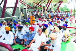 Members of the Toll Plaza Virodhi Sangharsh Committee at Solakhian toll plaza in Ropar on Wednesday.