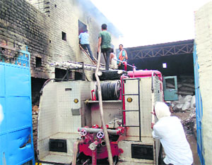 Fire brigade staff at work at the cotton factory in Abohar on Wednesday.