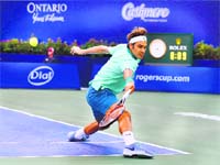 Roger Federer returns to Peter Polansky in the second round of the Rogers Cup in Toronto on Tuesday