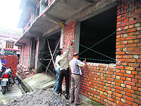 MDDA officials seal an under construction building in Dehradun on Wednesday. 