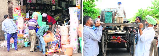 Panicked shopkeepers remove goods stacked on roadsides; and (right) MC officials load a rehri on a truck near Dharam Singh Market in Amritsar on Thursday. Photos: Vishal Kumar