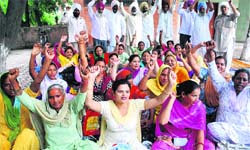 ASHA workers protest outside the office of the Civil Surgeon in Amritsar on Thursday. Photo: RK Soni