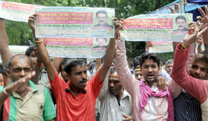 E-rickshaw drivers stage a protest against the Delhi High Court's ban on plying battery-operated rickshaws in the Capital, at Jantar Mantar in New Delhi on Thursday. 
