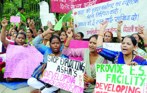 Activists of the  Delhi Committee of Pragatisheel Mahila Sangthan raise slogans during a demonstration for their various demands at Jantar Mantar in New Delhi on Thursday. 