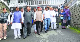 Former Chief Minister Prem Kumar Dhumal with other BJP MLAs raise slogans in the Vidhan Sabha complex after the adjournment of the House on the second day of the monsoon session in Shimla on Thursday.