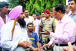 Chief Parliamentary Secretary Som Parkash listens to the grievances of protesting members of the Blind and Disabled Persons Union in Phagwara on Thursday