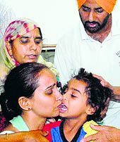 Harvanshbir Singh with his mother Navjot Kaur and other family members in Amritsar on Thursday