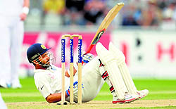 Ajinkya Rahane falls flat on his back while trying to negotiate a bouncer on Day One of the fourth Test at Old Trafford on Thursday